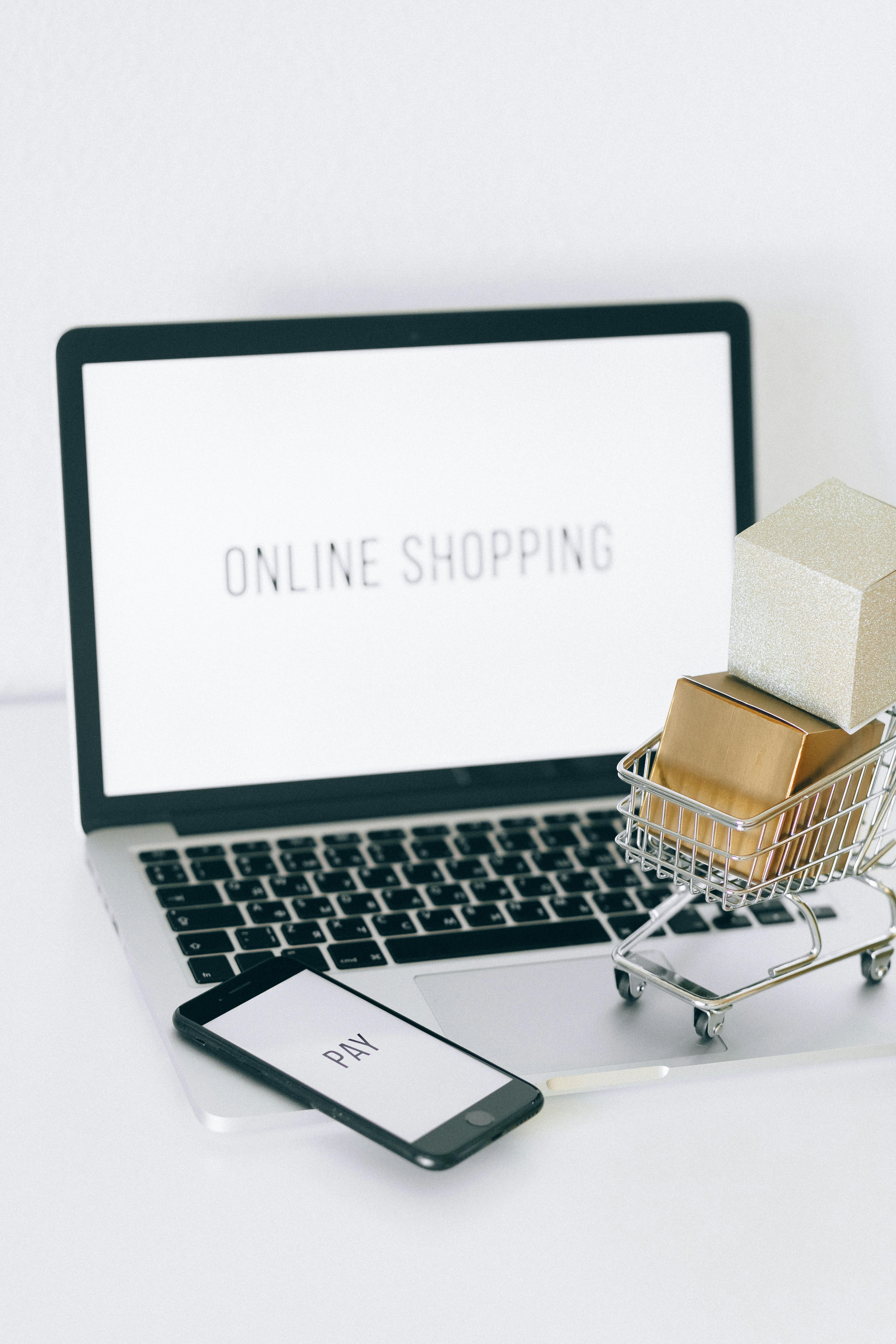 Laptop showing e-commerce analytics dashboard with shopping cart